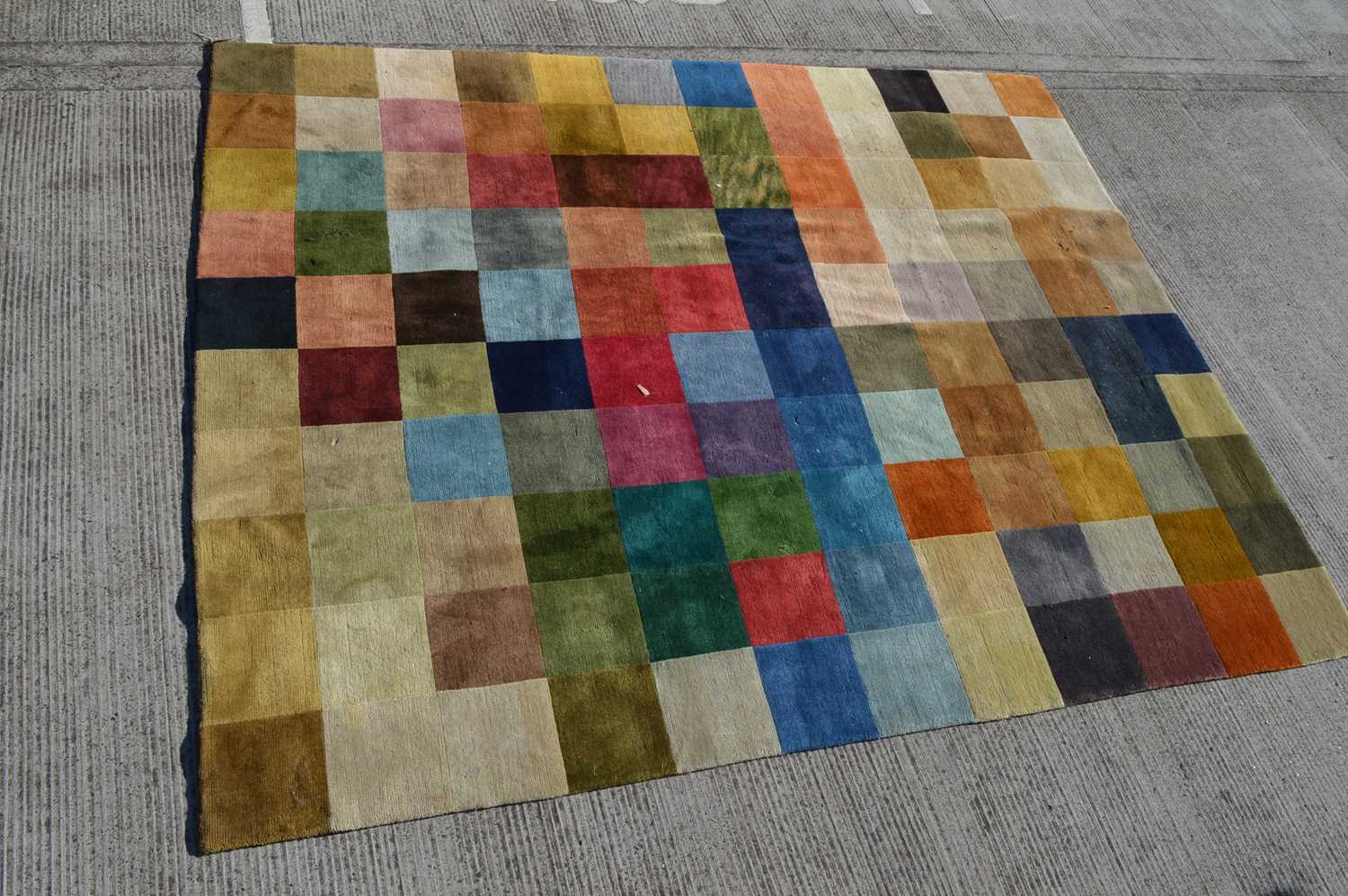 Lot 572 - A modern checkerboard carpet woven in colours,...