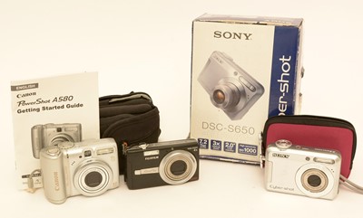 Lot 934 - Three digital compact cameras.