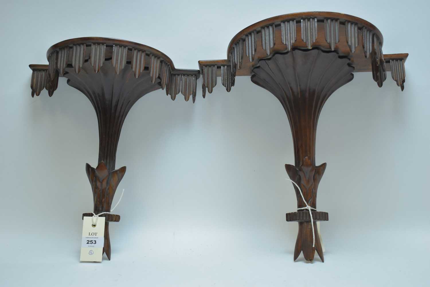 Lot 253 - Two carved wood wall brackets.