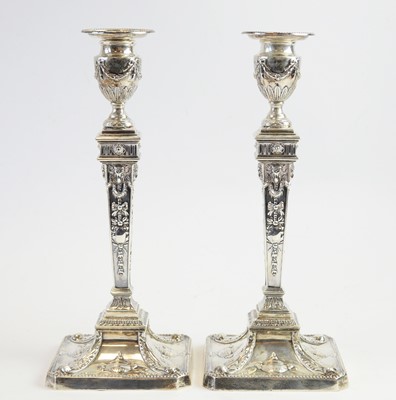 Lot 125 - A pair of Adams style candlesticks