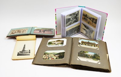 Lot 925 - Four albums of postcards and photographs.