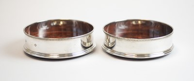 Lot 105 - A pair of modern silver mounted wine coasters