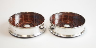 Lot 105 - A pair of modern silver mounted wine coasters
