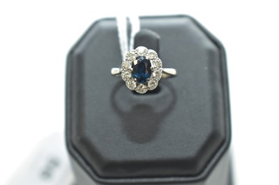 Lot 56 - A sapphire and diamond cluster ring
