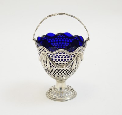 Lot 226 - A George III silver sugar basket with blue glass liner