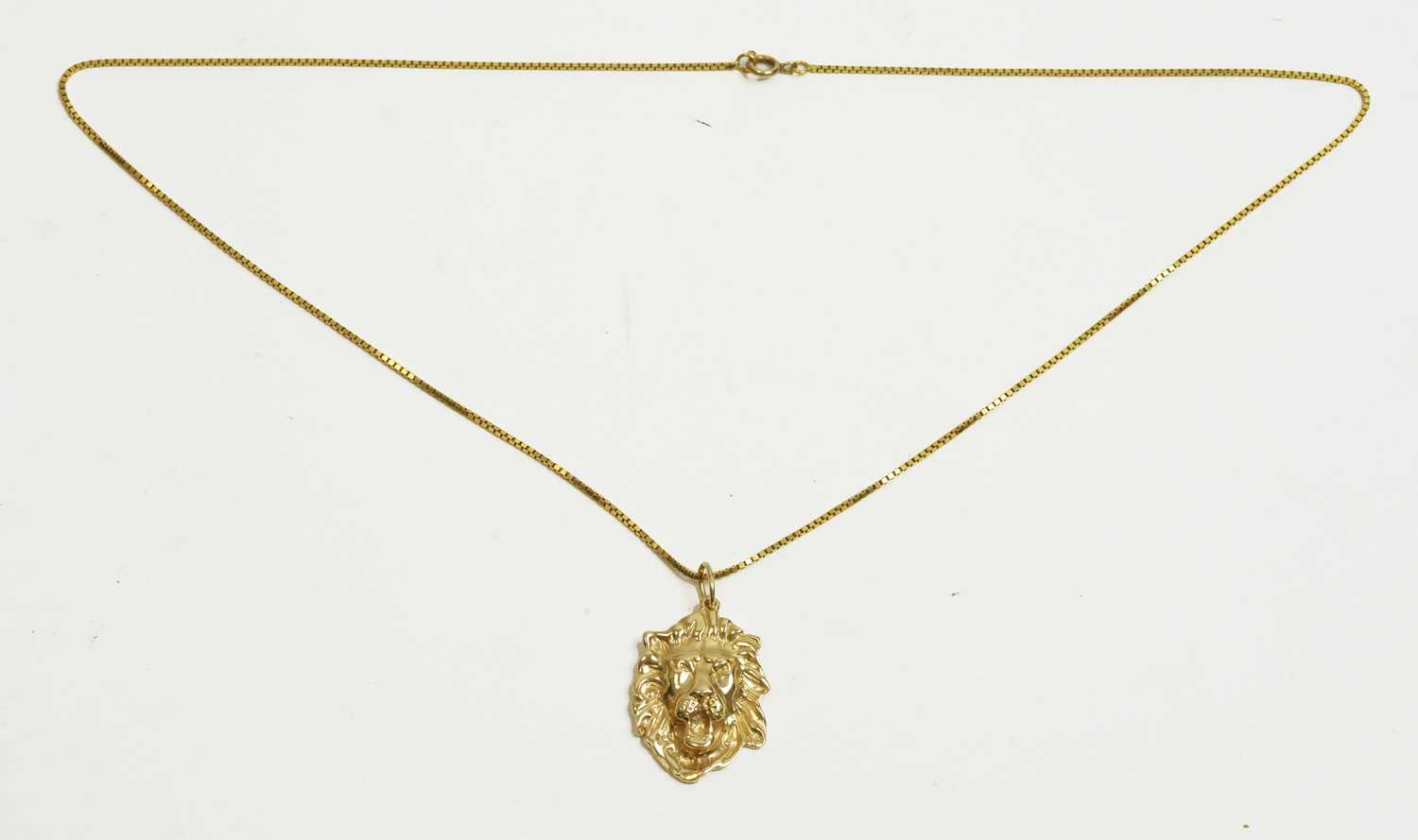 Lot 18 - Gold lion pattern pendant and chain
