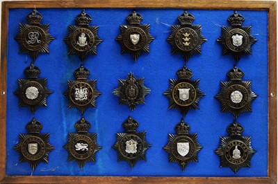 Lot 799 - A collection of 20th Century Police helmet badges, framed.