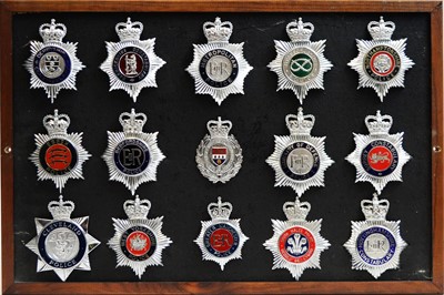 Lot 808 - A collection of 20th Century Police helmet badges, framed.
