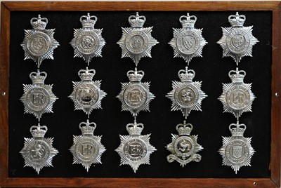 Lot 811 - A collection of 20th Century Police helmet badges, framed.