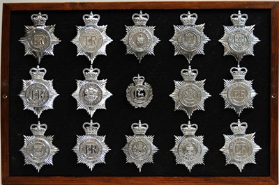 Lot 812 - A collection of 20th Century Police helmet badges, framed.