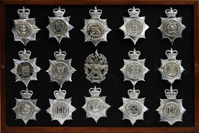 Lot 813 - A collection of 20th Century Police helmet badges, framed.