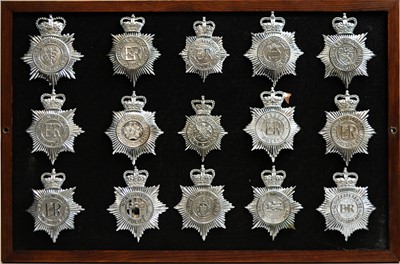 Lot 814 - A collection of 20th Century Police helmet badges, framed.