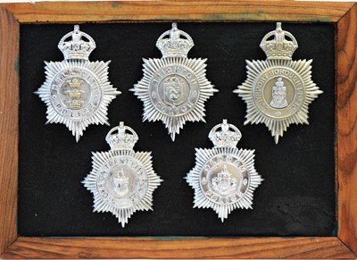 Lot 801 - A collection of 20th Century Police helmet badges, framed.