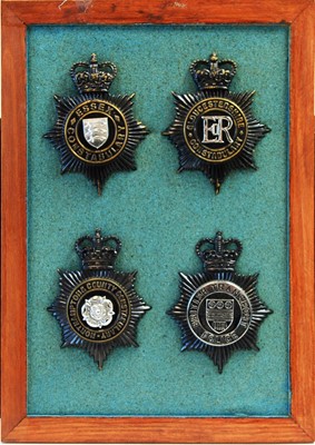 Lot 803 - A collection of 20th Century Police helmet badges, framed.