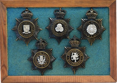 Lot 806 - A collection of 20th Century Police helmet badges, framed.