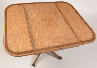 Lot 894 - A late George III satinwood and banded drop-leaf table.