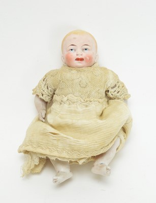 Lot 1009 - A 19th Century bisque miniature baby doll.