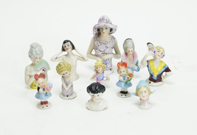 Lot 1011 - Pincushion dolls in glazed ceramic.