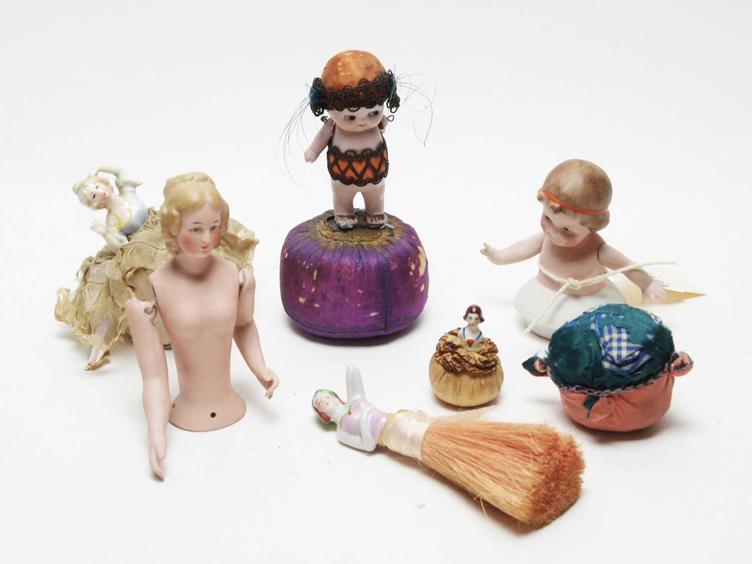 Lot 1013 - A 19th Century bisque pincushion doll, and five others, various.