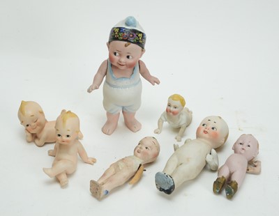 Lot 1014 - Two German and one bisque Kewpie piano-baby dolls; and five others, various.