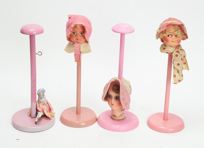 Lot 1024 - Chad Valley, England: four pink-painted display stand dolls.