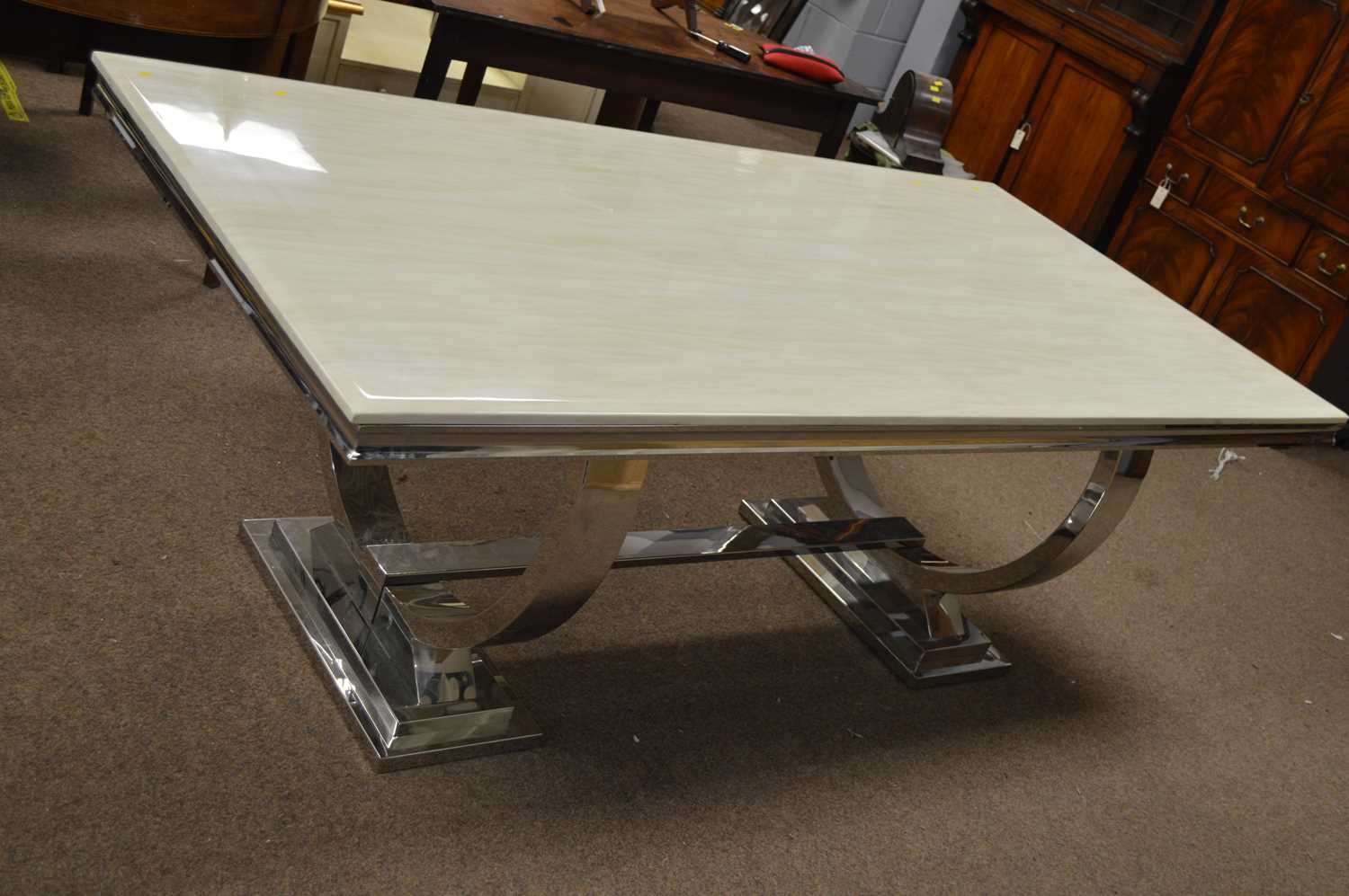Lot 577 - A modern chrome dining table.