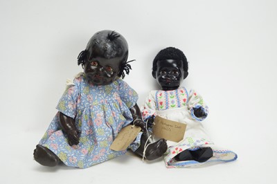 Lot 1039 - An early 20th Century composition black baby doll; and another doll by Pedigree.
