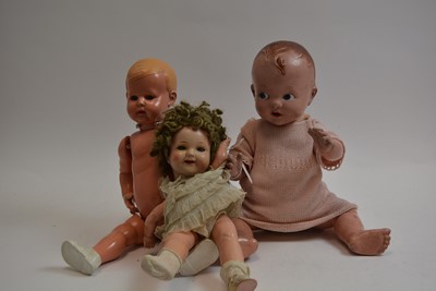 Lot 1040 - A mid 20th C German "Shirley Temple" doll; and two baby dolls by Pedigree and Minerva.