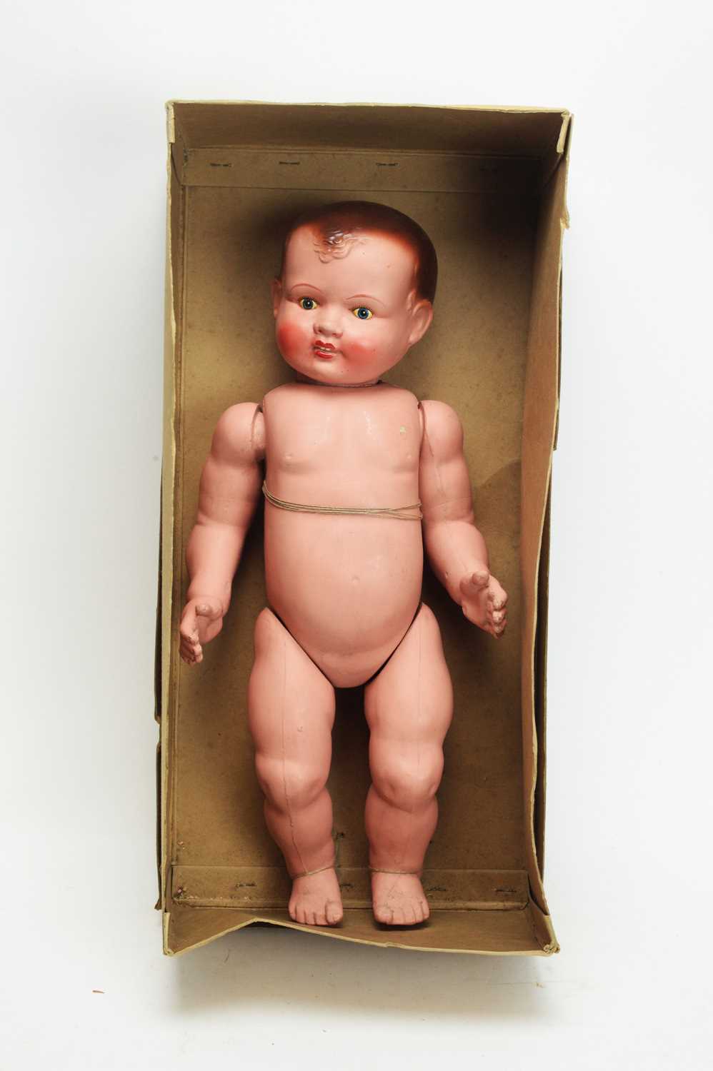 Lot 1050 - An early 20th Century painted composition baby doll.