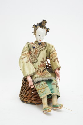 Lot 1079 - A late 19th/early 20th Century Chinese opera doll; and a wicker chair.