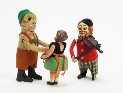 Lot 1140 - Schuco, Germany: a clockwork boy and baby sister automaton toy; and a clown violinist.