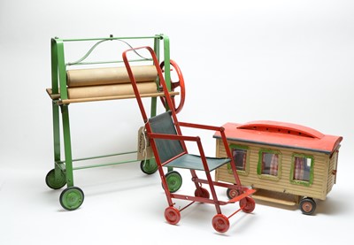 Lot 1152 - Tri-ang, England: a toy mangle; folding pushchair; and toy caravan.