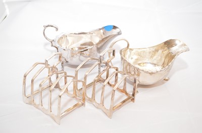 Lot 47 - Two silver sauce boats; and two plated toast racks