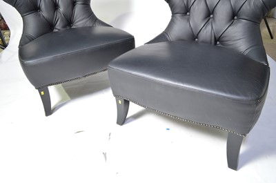Lot 48 - A pair of designer faux black leather easy chairs.