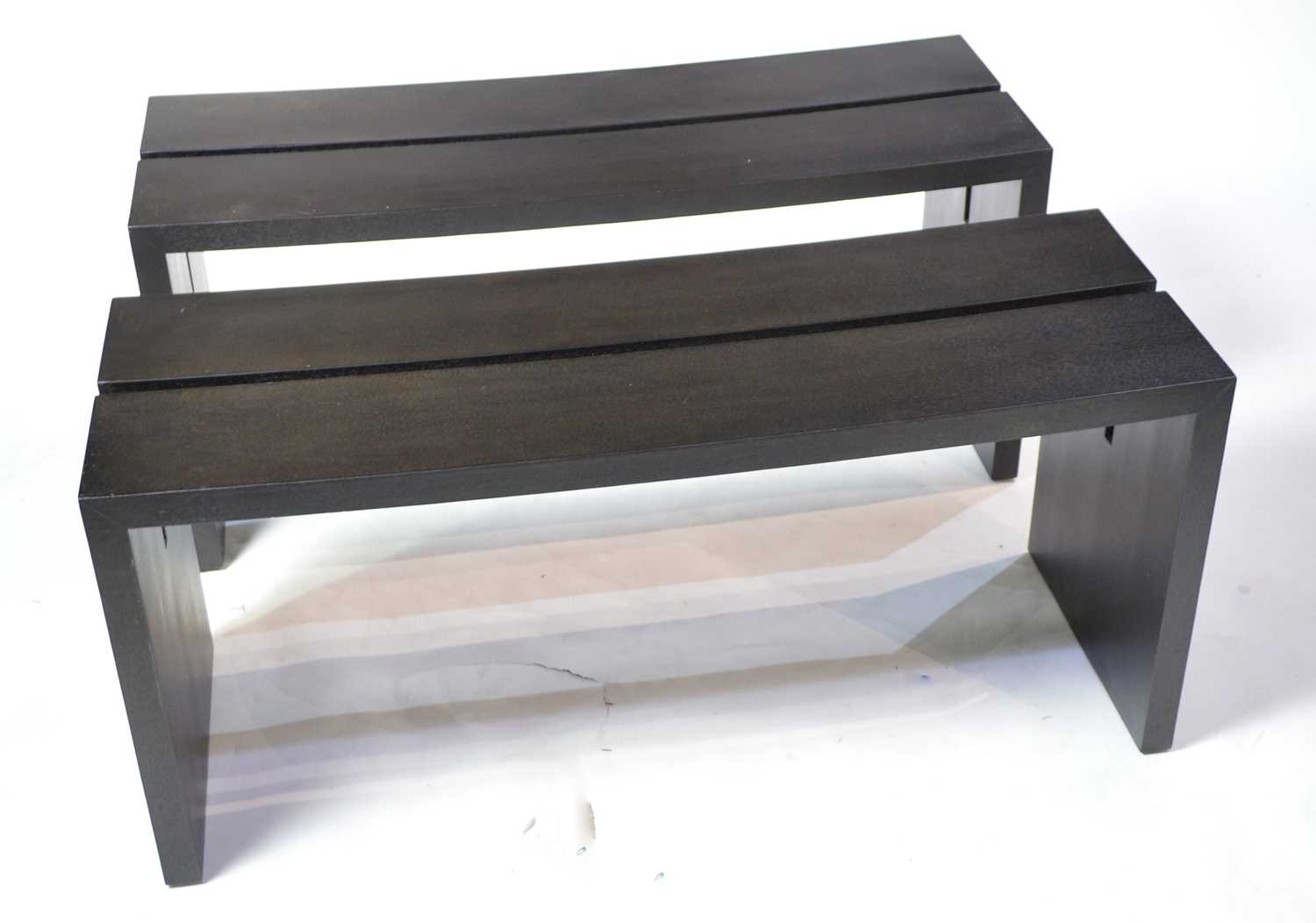 Lot 52 - A pair of designer ebonised benches.