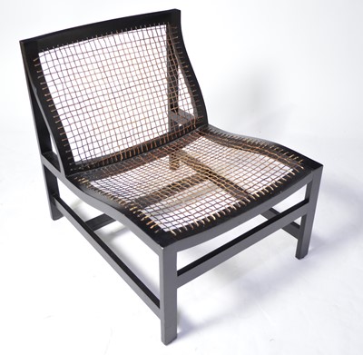 Lot 55 - Modern canework and ebonised easy chair.