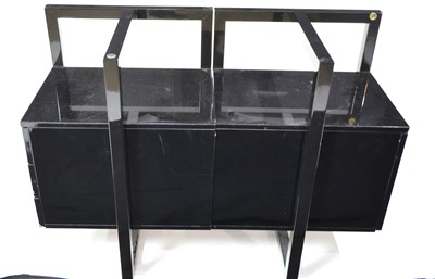 Lot 57 - A modern black lacquered and glass desk.