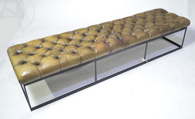 Lot 64 - A faux leather button upholstered bench.