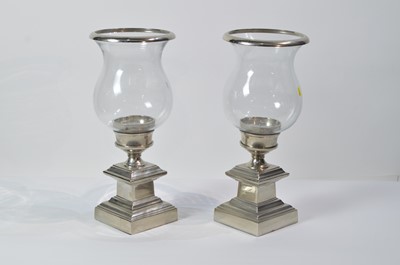 Lot 30 - Eichholtz: a pair of glass and metal urn pattern candle stands.