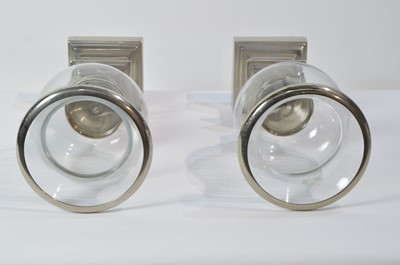 Lot 30 - Eichholtz: a pair of glass and metal urn pattern candle stands.