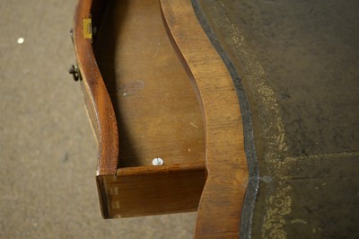 Lot 4 - A Georgian style mahogany serpentine front pedestal desk.