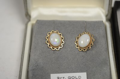 Lot 57 - A pair of opal earrings; and two locket pendants.