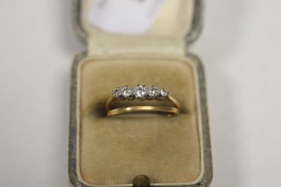 Lot 9 - A five stone diamond ring; and a wedding band.