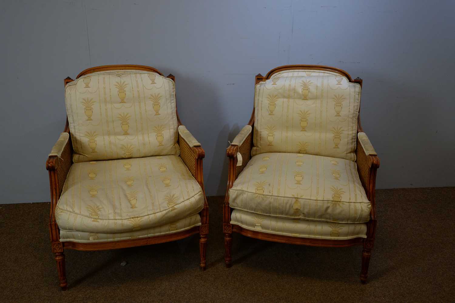 Lot 124 - A pair of 20th Century French-style beechwood Bergere armchairs.