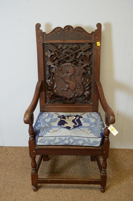 Lot 146 - Ceremonial-style carved oak open arm chair with crest and motto.