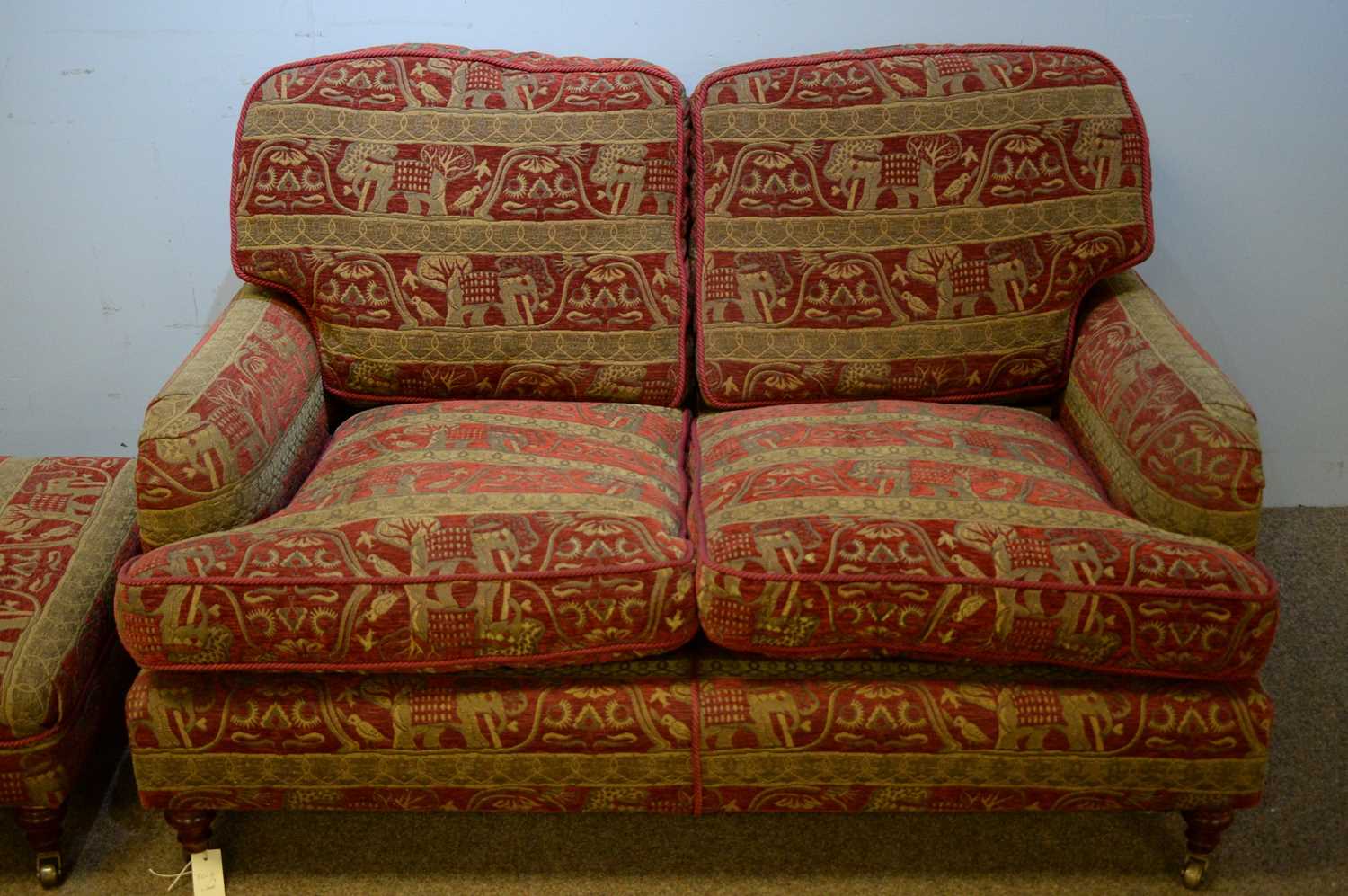 Lot 6 Twoseater sofa and matching footstool.