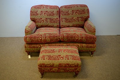 Lot 6 - Two-seater sofa and matching footstool.
