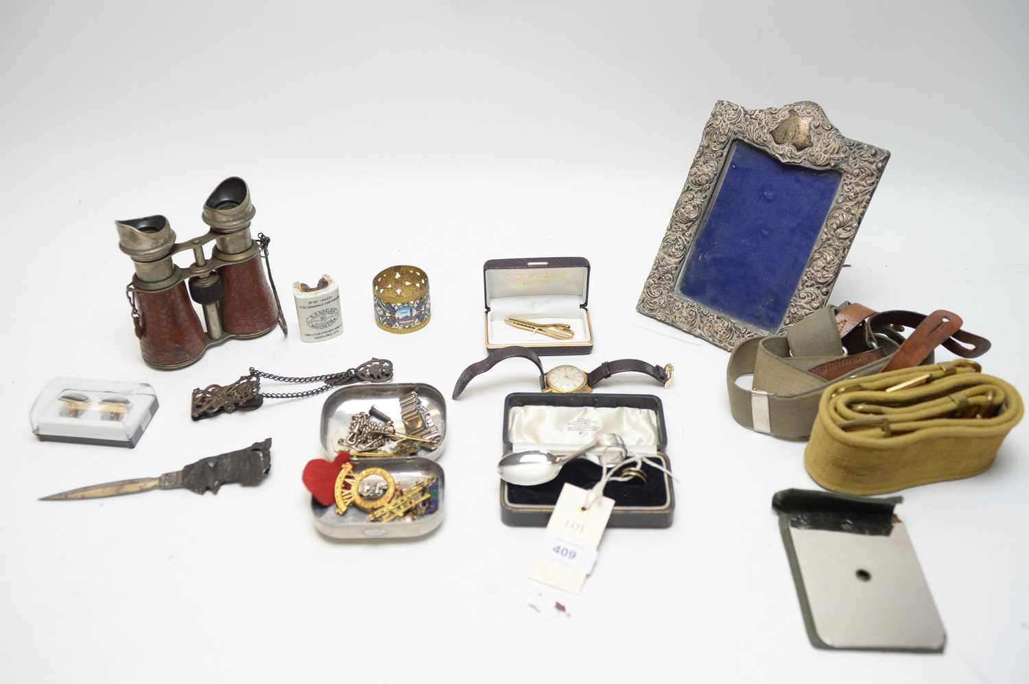 Lot 409 - Military badges belts and field glasses; and other items