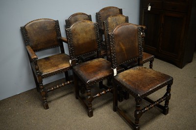 Lot 130 - Six Carolean style oak dining chairs; and a plank top refectory style dining table.