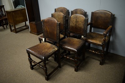 Lot 130 - Six Carolean style oak dining chairs; and a plank top refectory style dining table.